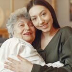 Old woman in a cafe with young granddaughter