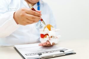 A doctor uses an anatomical lumbar disc herniation model to explain spinal health