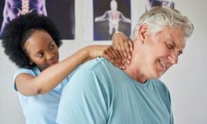 Healthcare, neck pain and a black woman chiropractor with a patient in her office for rehabilitatio